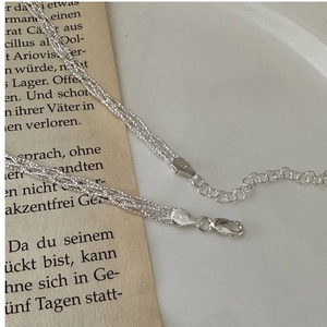 Macro shot of S925 sterling silver woven necklace with lobster clasp and stamp