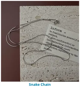 Dettaglio macro della catena a serpente in argento 925 lucido su trama di pietra