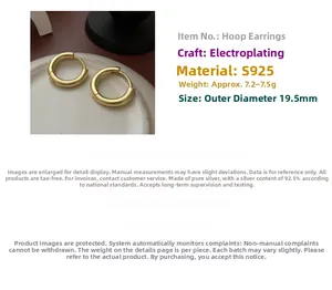 Detail view of gold hoop earrings showing 19.5mm diameter and S925 sterling silver stamp