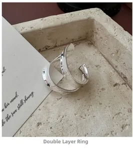 Detailed macro of S925 sterling silver double-layer ring with minimalist curved design