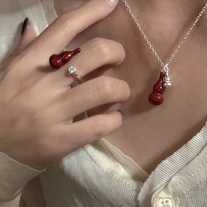 Angola red gourd pendant necklace and open ring set in silver on a model
