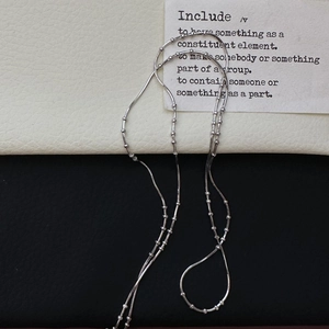 Minimalist S925 sterling silver snake chain necklace with small beads on a clean background