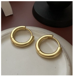 Macro shot of S925 sterling silver stamp on the inner matte gold hoop earring