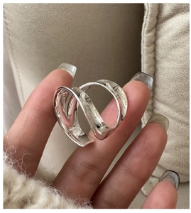 Macro shot of S925 sterling silver wide curved ring with artistic spiral design