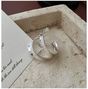 Detail view of S925 sterling silver wide curved ring with hallmark and polished finish