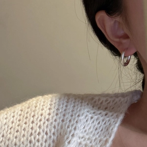 Minimalist S925 sterling silver frosted hoop earring on a model in a warm setting