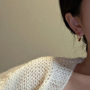 Minimalist S925 sterling silver matte gold hoop earrings worn on a model with knitwear