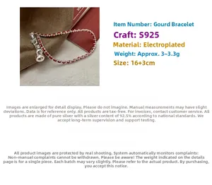 Detail of S925 sterling silver gourd pendant on a red braided string bracelet