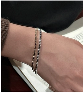 Detail of minimalist S925 sterling silver bracelets with black crystals on a female wrist