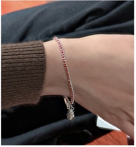 Close-up of S925 silver red string bracelet with small gourd and bell charm detail