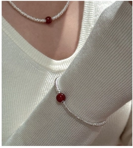 Detail of S925 silver chain bracelet and necklace featuring elegant red agate beads