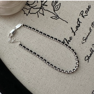 Detail of S925 sterling silver beads and black woven rope bracelet with lobster clasp