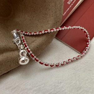 S925 sterling silver red string bracelet with a polished gourd charm and bead detail