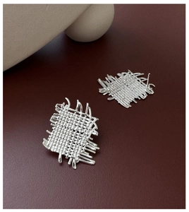 Detailed close-up of S925 sterling silver earrings with textured woven metal design