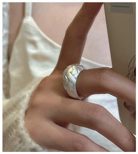 Close-up of S925 sterling silver wide braided ring with vintage matte woven texture