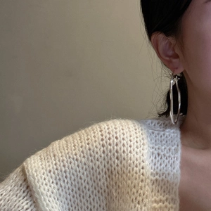 Minimalist S925 sterling silver hoop earrings worn with a beige knitted cardigan