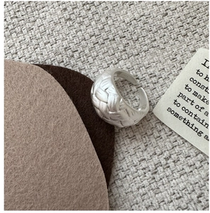 Macro detail of S925 sterling silver ring showing woven texture and quality hallmark