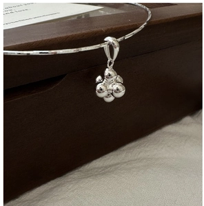 Detailed close-up of a S925 sterling silver clustered beads pendant on a sleek collar