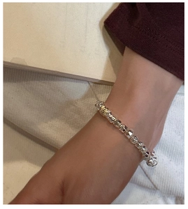 Detail of silver faceted bead bracelet showing minimalist geometric design and metallic texture