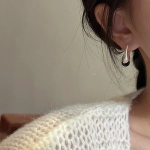 Minimalist S925 silver earrings with black onyx bead charms worn on earlobe