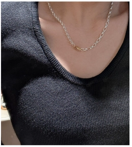 Close-up of S925 sterling silver chain necklace with gold and silver contrasting links