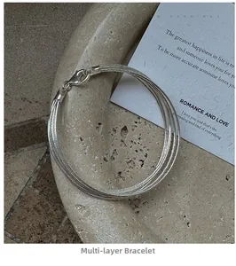 Detail of elegant multilayer S925 sterling silver chain bracelet with lobster clasp closure