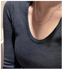 Detail of S925 sterling silver chain necklace with polished oval links on a sweater