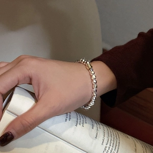 Minimalist S925 silver beaded bracelet with a contrasting gold bead accent for women