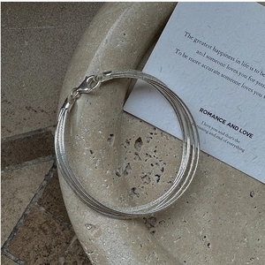 Close-up of S925 sterling silver multi-strand necklace with lobster clasp on stone tray