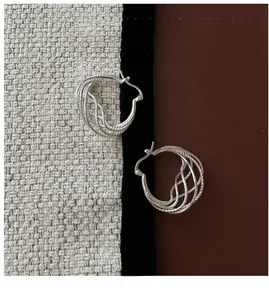 Detailed view of S925 sterling silver hollow earrings with twisted rope texture