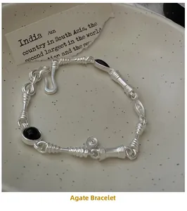 Detail of vintage S925 silver bracelet with black agate inlay and twisted metal texture