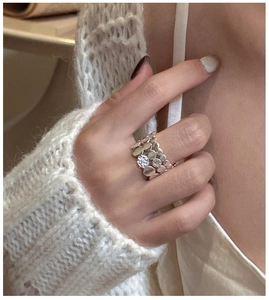 Detail of silver S925 tiered ring with zircon on hand, elegant vintage aesthetic