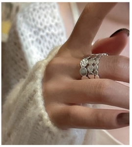 Macro shot of tiered S925 sterling silver ring showing stacked disc detail and texture