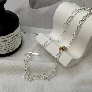 S925 sterling silver paperclip chain necklace with gold clasp on minimalist stand