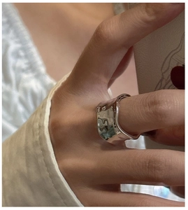Detail of S925 sterling silver ring featuring irregular liquid metal wave texture design