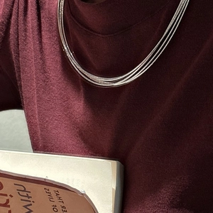 Three-layer S925 sterling silver chain necklace over a burgundy sweater collar