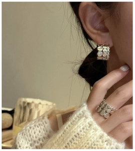 Close-up of S925 sterling silver triple-layer rings and matching scales texture earrings