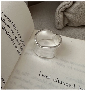 Macro detail of silver hammered texture on wide wavy adjustable sterling silver open ring