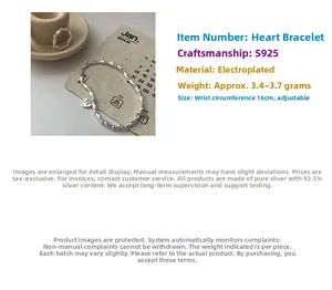 Detailed macro of S925 sterling silver beaded bracelet and heart pendant on jewelry tray