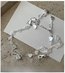 Detailed shot of S925 silver heart pendants on a chain with lobster clasp and extender