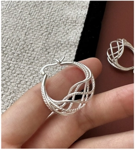Macro detail of S925 sterling silver mesh woven hoop earrings with intricate texture