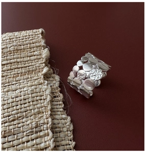 Detail of S925 sterling silver triple layer ring with hammered texture and hollow design