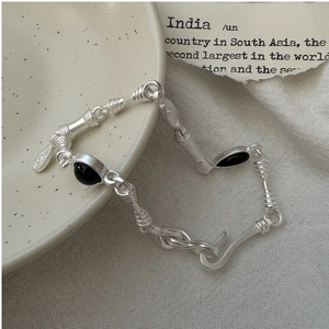 Detail of S925 silver bamboo link bracelet with black agate and classic S-hook closure