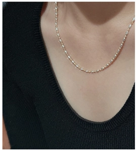 Close-up of dual-tone S925 silver faceted olive beads and gold round beads necklace