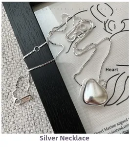 Macro detail of S925 sterling silver matte heart pendant with a fine box chain necklace