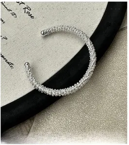 Detailed macro view of S925 sterling silver beaded cuff bracelet with a textured finish