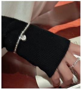 Close-up of S925 sterling silver beaded bracelet with heart pendant and matching ring set