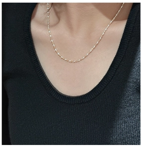 Close-up of S925 sterling silver two-tone gold and silver link necklace worn on neck