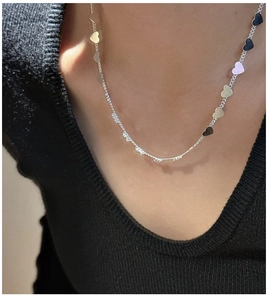 Polished S925 sterling silver heart necklace worn on neck with minimalist styling
