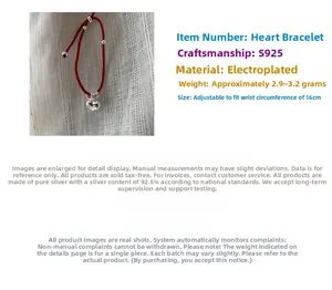 Detail view of adjustable red string bracelet featuring a S925 heart pendant charm